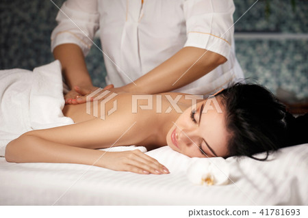Relaxed woman receiving massage Relaxed woman receiving massage 41781693