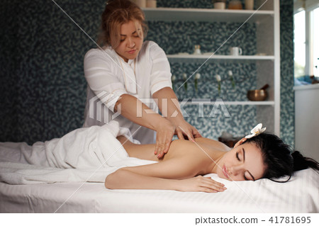 Relaxed woman receiving massage Relaxed woman receiving massage 41781695