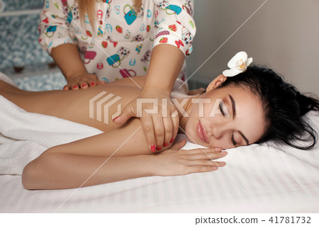 Relaxed woman receiving massage Relaxed woman receiving massage 41781732