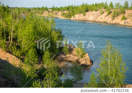 Photo of picturesque hilly area with vegetation and blue lake 41782536