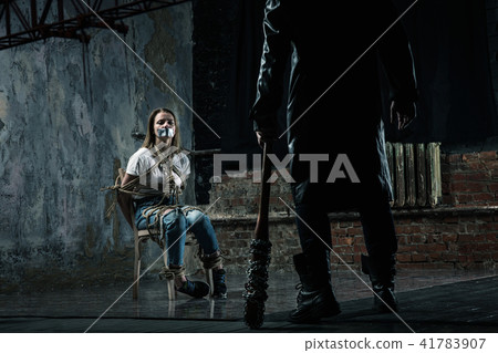 Serial maniac prepares to kill his female victim Serial maniac prepares to kill his female victim 41783907