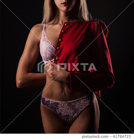 Blonde young woman in lace lingerie and red jacket Blonde young woman in lace lingerie and red jacket 41784725