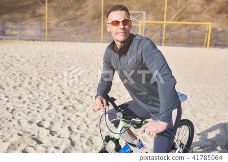 Cyclist with bike on the sand Cyclist with bike on the sand 41785064