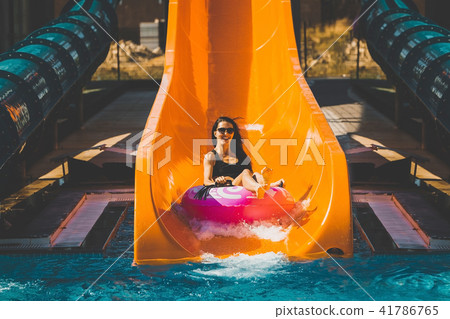 girl going down by the slide in aqua park girl going down by the slide in aqua park 41786765