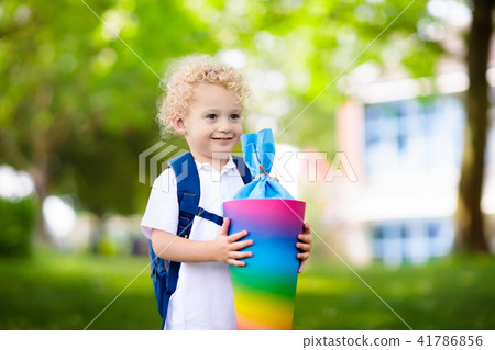 Little child with candy cone on first school day 41786856