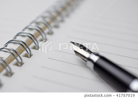expensive pen on notebook 41787019