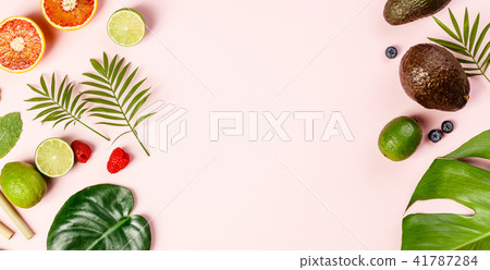 Tropical fruits and leaves on pink pastel background Tropical fruits and leaves on pink pastel background 41787284