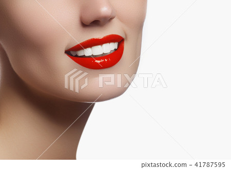 Woman applying lipstick. Model painted red lips Woman applying lipstick. Model painted red lips 41787595