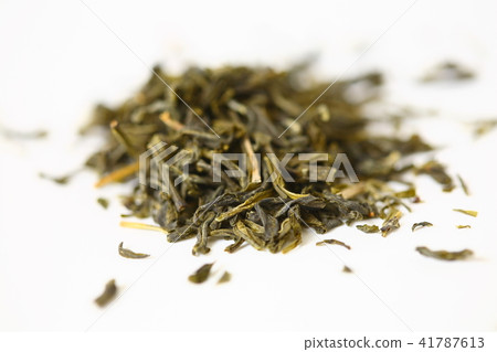 Pile of green tea on white background. Shallow dof Pile of green tea on white background. Shallow dof 41787613