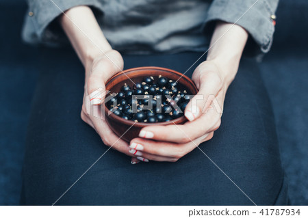 Berries of black currant in plates Berries of black currant in plates 41787934