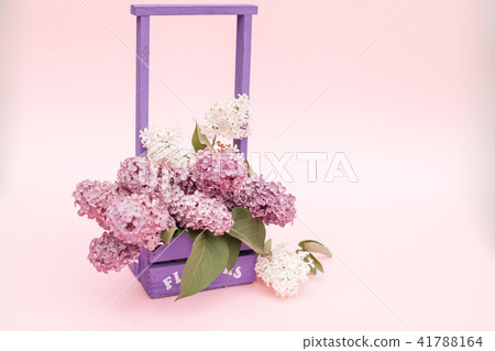 Lilac flowers bunch in a violet wooden basket Lilac flowers bunch in a violet wooden basket 41788164