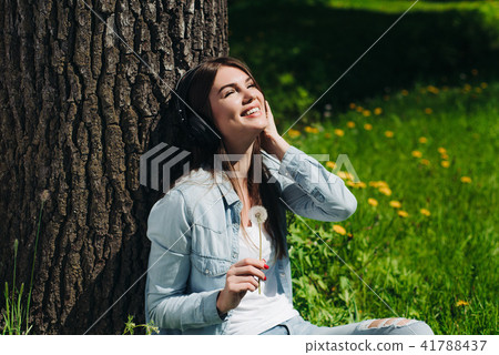 Woman with headphones in park Woman with headphones in park 41788437