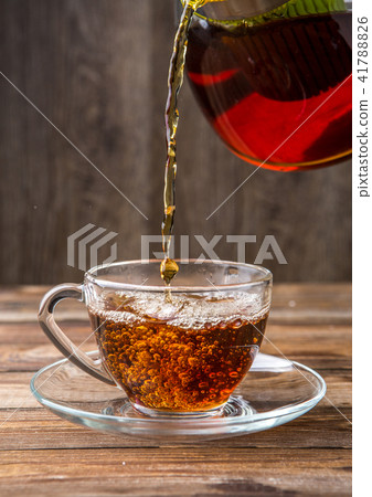 Black tea poured from teapot Black tea poured from teapot 41788826