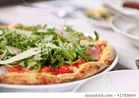 Delicious and freshly baked Prosciutto pizza. 41789064