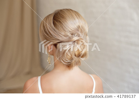 Rear view of female hairstyle middle bun with blond hair Rear view of female hairstyle middle bun with blond hair 41789137