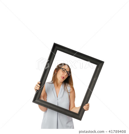 Woman making faces behind black frame 41789408