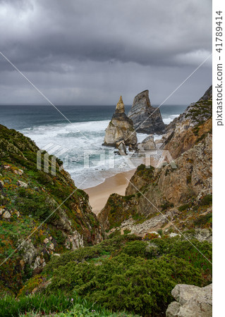 Praia da Ursa beach under stormy clouds 41789414
