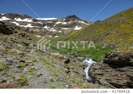 Hikers ascending mountain panorama 41789416