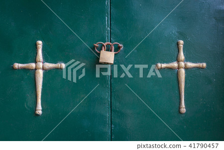 Crucifixion hanging in the door side by side. A 41790457