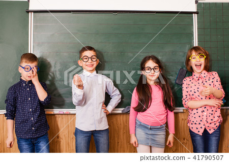 Cool pupils in glasses have fun together during the break Cool pupils in glasses have fun together during the break 41790507