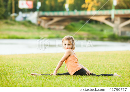 Happy girl doing stretching exercises in park Happy girl doing stretching exercises in park 41790757