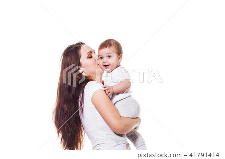 Beautiful young mother kisses her child 41791414