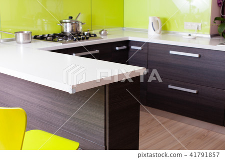 Desighned wooden kitchen with yellow chair Desighned wooden kitchen with yellow chair 41791857