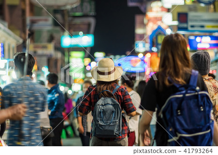 Back side of Young Asian traveling women walking and looking in Khaosan Road walking street in night time at Bangkok, Thailand, traveler and tourist concept Back side of Young Asian traveling women walking and looking in Khaosan Road walking street in night time at Bangkok, Thailand, traveler and tourist concept 41793264