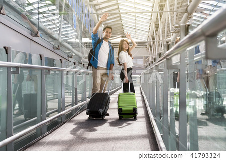 Asian couple traveler with suitcases at the airport. Lover travel and transportation with technology concept. 41793324