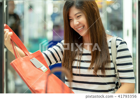 Happy Asian woman choosing the women bag store shop with happy action at department center 41793356