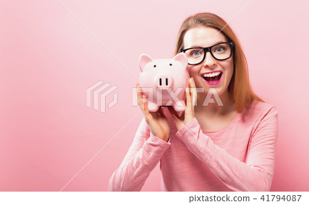 Young woman with a piggy bank 41794087