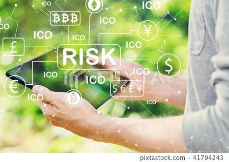 Cryptocurrency ICO risk theme concept with man holding his table 41794243