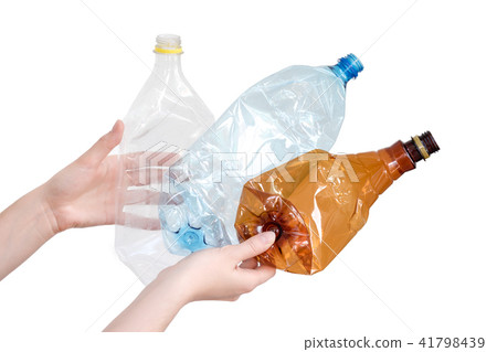 Female hand holding empty plastic bottle isolated Female hand holding empty plastic bottle isolated 41798439