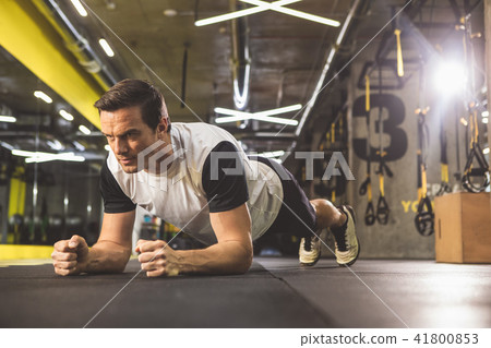 Happy man doing static exercise in gym Happy man doing static exercise in gym 41800853