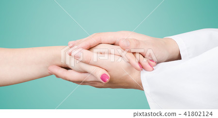 Doctor holding patient hand close up Doctor holding patient hand close up 41802124