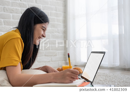 Asian female freelancer working on laptop 41802309