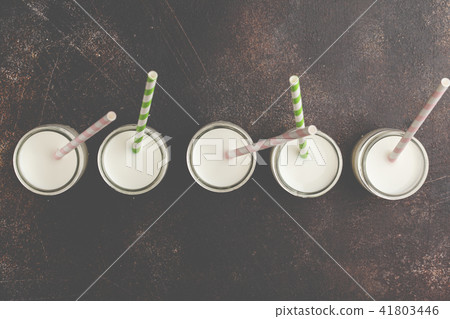 Milk (vegan nuts milk) in glass bottles  41803446