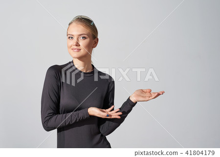 Woman in black shirt showing blank copy space in side 41804179