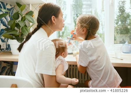 The happy smiling caucasian family in the kitchen preparing breakfast 41805226