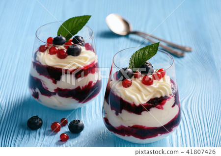 Berry mascarpone mousse dessert, on blue table. 41807426