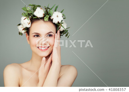 Happy young woman with cotton flowers and green leaves on banner 41808357