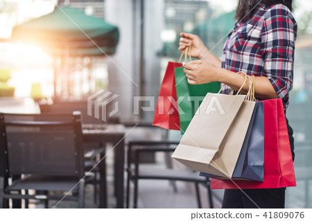 Woman holding shopping bags on the mall background 41809076
