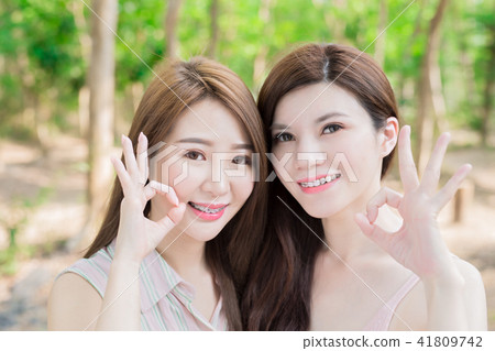 two beauty women smile happily two beauty women smile happily 41809742