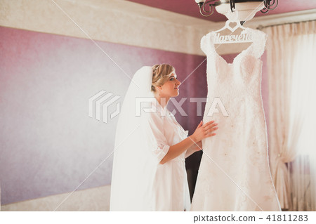 Beautiful bride wearing fashion wedding dress with feathers with luxury delight make-up and Beautiful bride wearing fashion wedding dress with feathers with luxury delight make-up and 41811283