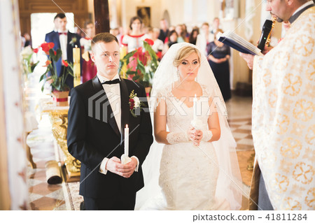 Married couple posing in a church after ceremony 41811284