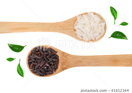 white and black rice grains in wooden spoon isolated on white background. Top view. Flat lay white and black rice grains in wooden spoon isolated on white background. Top view. Flat lay 41812164