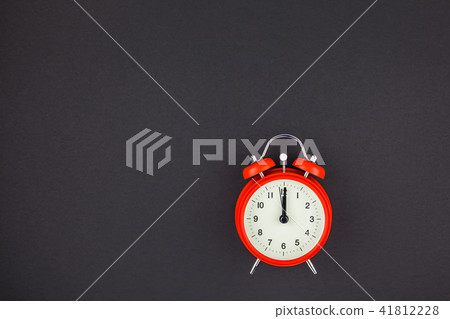 Red vintage alarm clock on dark background Red vintage alarm clock on dark background 41812228