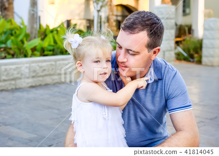 Portrait of toddler girl hugging her father  41814045