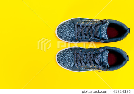 Women's sport shoes isolated on yellow background Women's sport shoes isolated on yellow background 41814385