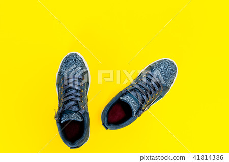 Women's sport shoes isolated on yellow background Women's sport shoes isolated on yellow background 41814386